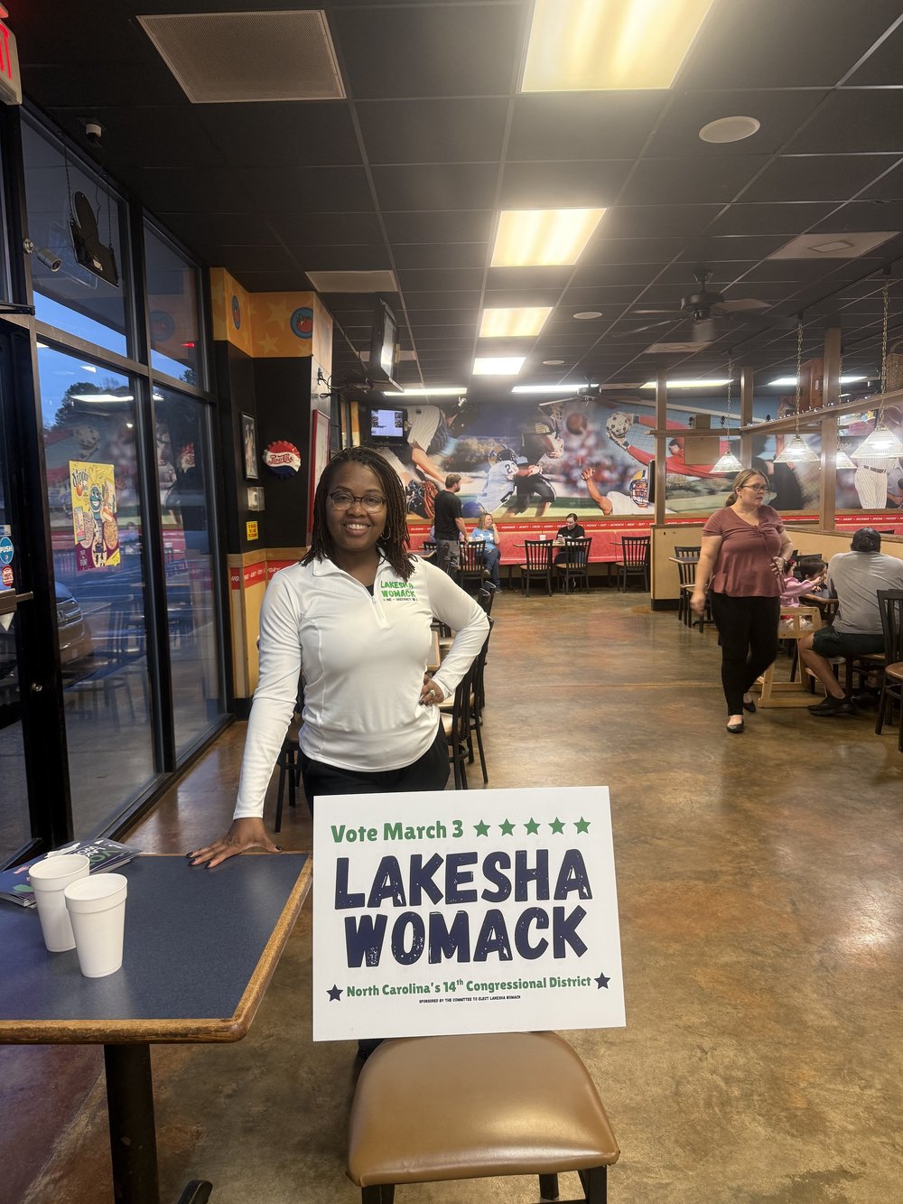 LaKesha Womack with supporters at a local business